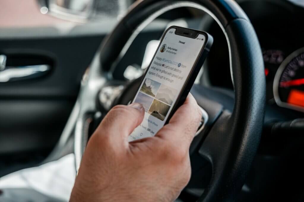 Twitter on mobile phone at steering wheel