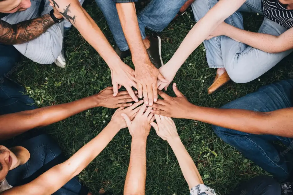 people stacking hands together